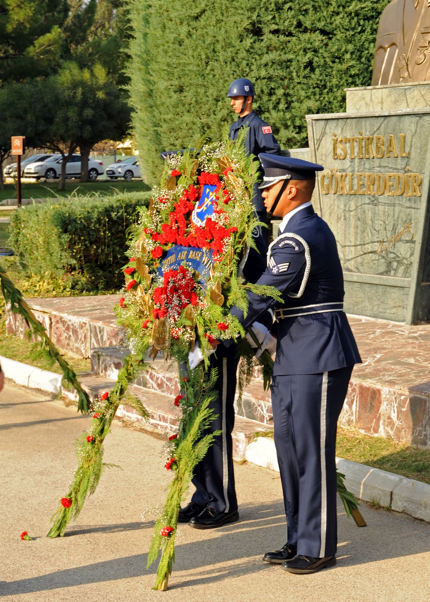 Senior Airman Steven Lacefield, 39th Logistics Readiness Squadron logistics plans journeyman, and Staff Sgt. Michael Sheppard, 39th LRS vehicle maintenance core contracting officer representative, lay a wreath in honor of Mustafa Kemal Ataturk Nov. 10, 2013, at Incirlik Air Base, Turkey. Every year on the day and time that Ataturk died, all of Turkey pauses for a two-minute moment of silence to honor him. (U.S. Air Force photo by Senior Airman Chase Hedrick/Released)