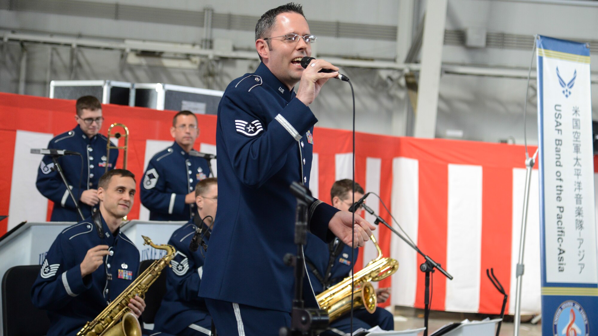 Staff Sgt. Geoff Fisher, Band of the Pacific-Asia vocalist, sings during the opening ceremony of the Iruma Air Show at Iruma Air Base, Japan, Nov. 3, 2013.  The band performed songs in both English and Japanese to entertain the attendants.  (U.S. Air Force photo by Airman 1st Class Soo C. Kim / Released)