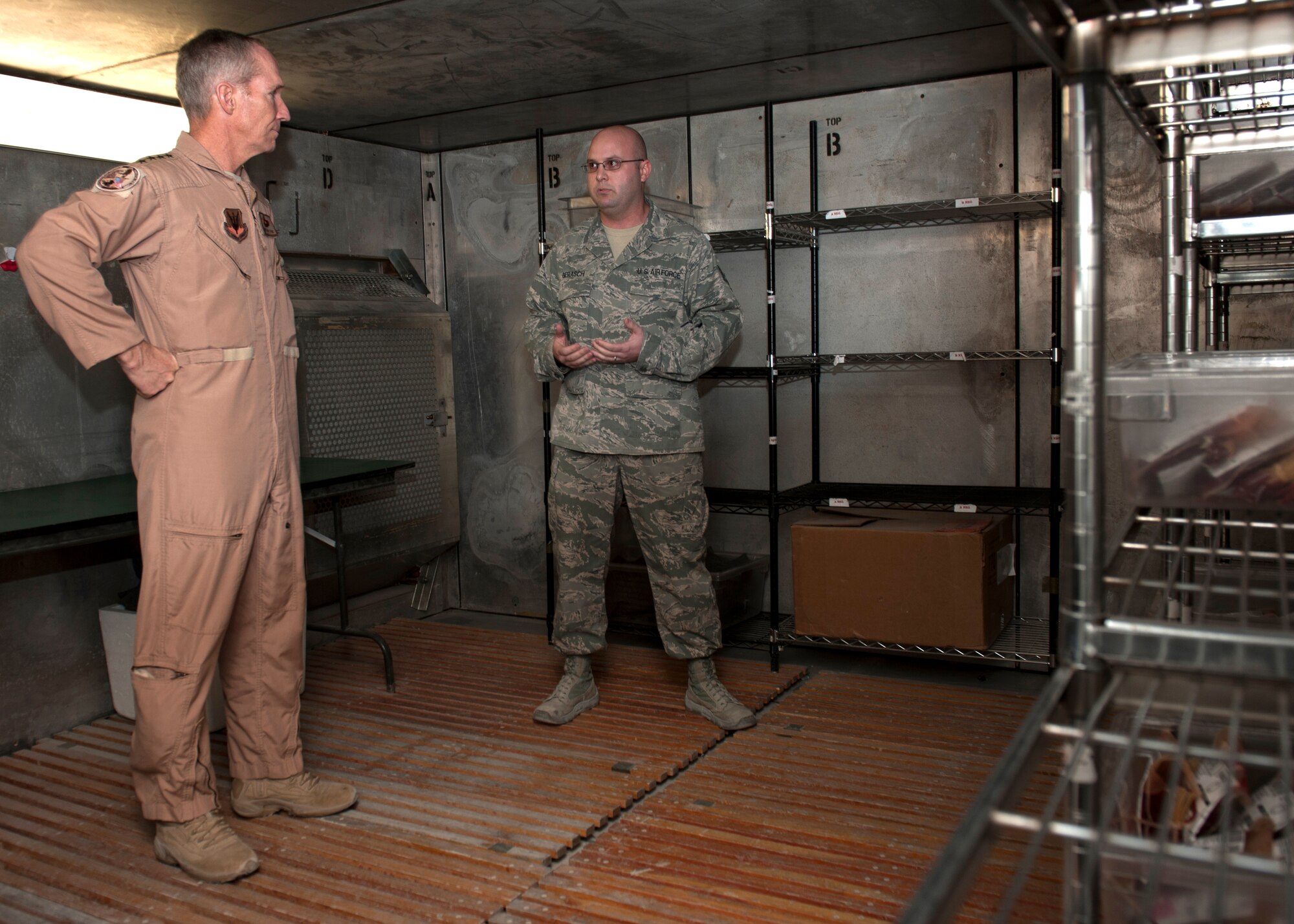 Gen. Mike Hostage is briefed by Staff Sgt. Aaron Gerasch about storing procedures for fresh blood in the Blood Transshipment Center at the 379th Air Expeditionary Wing in Southwest Asia, Nov. 11, 2013. The blood is scanned into an electronic database for accountability, then sorted and refrigerated at a temperature between 33 and 48 degrees Fahrenheit. Hostage is the commander of Air Combat Command. Gerasch is the 379th Expeditionary Medical Support Squadron BTC NCO in charge deployed from Eglin Air Force Base, Fla. (U.S. Air Force photo/Senior Airman Bahja J. Jones) 