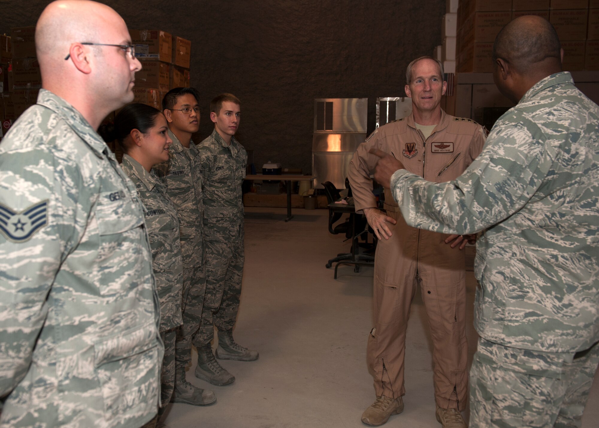 Gen. Mike Hostage receives a briefing at the Blood Transshipment Center at the 379th Air Expeditionary Wing in Southwest Asia, Nov. 11, 2013. The 379th Expeditionary Medical Group BTC is the hub for distributing blood products throughout the U.S. Air Forces Central Command area of responsibility. During his immersion, Hostage visited the Airman and Family Readiness Center, the BTC and the 71st Expeditionary Air Control Squadron. Hostage is the commander of Air Combat Command. (U.S. Air Force photo/Senior Airman Bahja J. Jones) 
