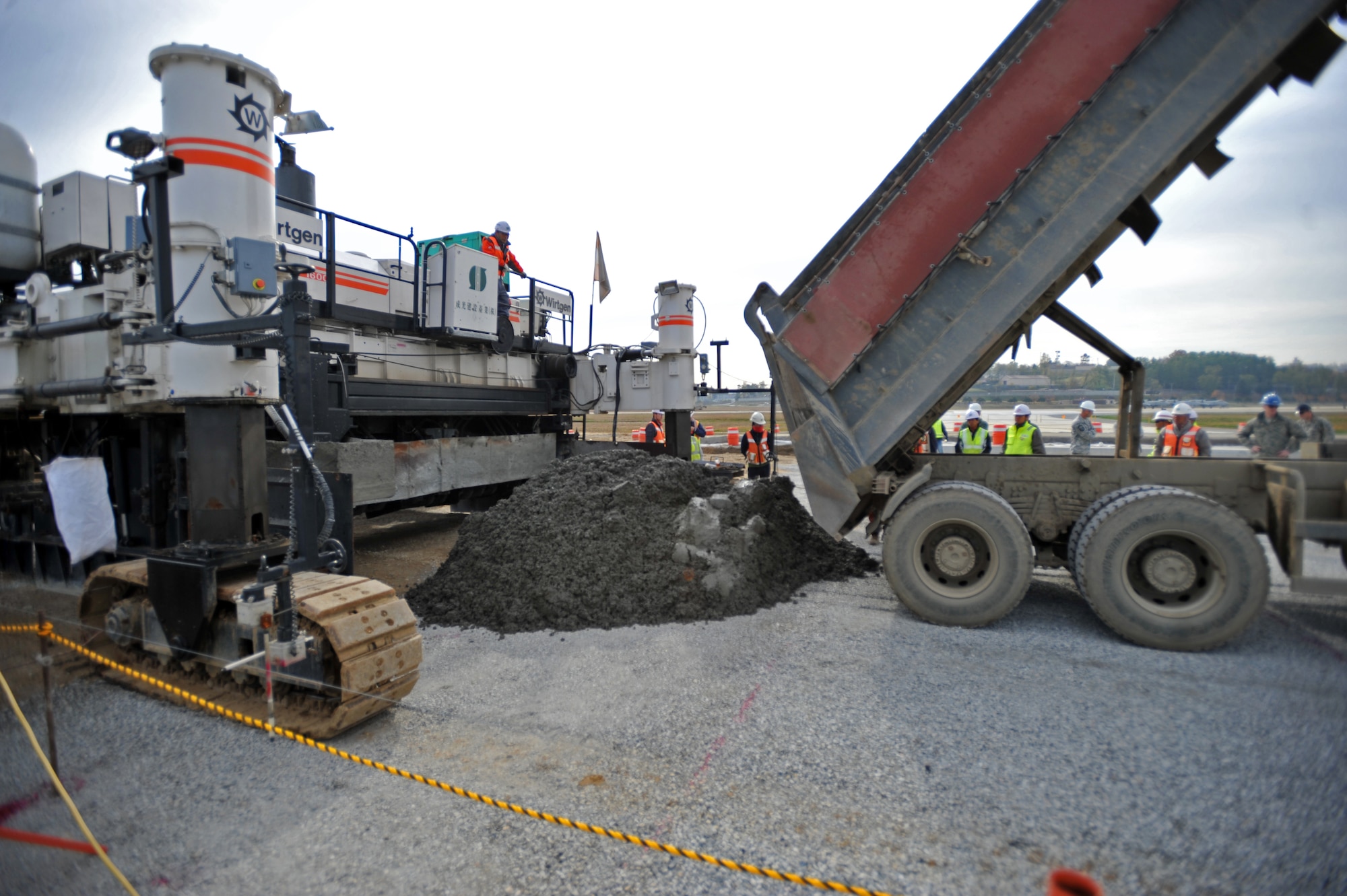 A dump truck unloads special cement mix at Osan Air Base, Republic of Korea, Nov. 8, 2013. This particular batch of cement mix was used to pave the first section of Osan’s second runway. (U.S. Air Force photo/Senior Airman Siuta B. Ika)