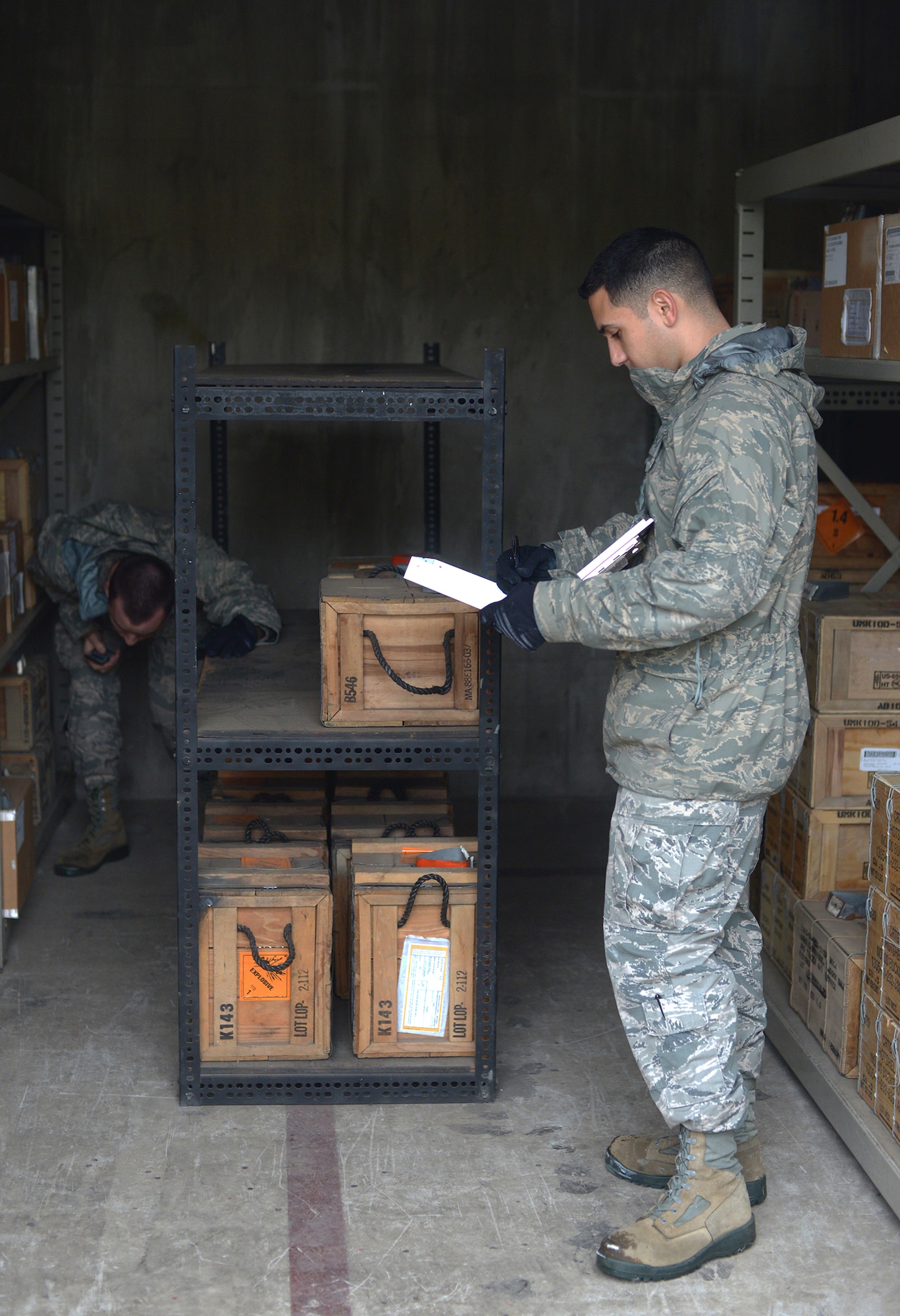 Senior Airmen Tyler Burtrum and Daniel Brito, 374th Maintenance Squadron, conduct a 10 percent stockpile inventory at Yokota Air Base, Japan, Nov. 7, 2013. Regular checks of the munitions stockpile ensure reliability to and readiness for the mission. (U.S. Air Force photo by Airman 1st Class David Danford/Released)
