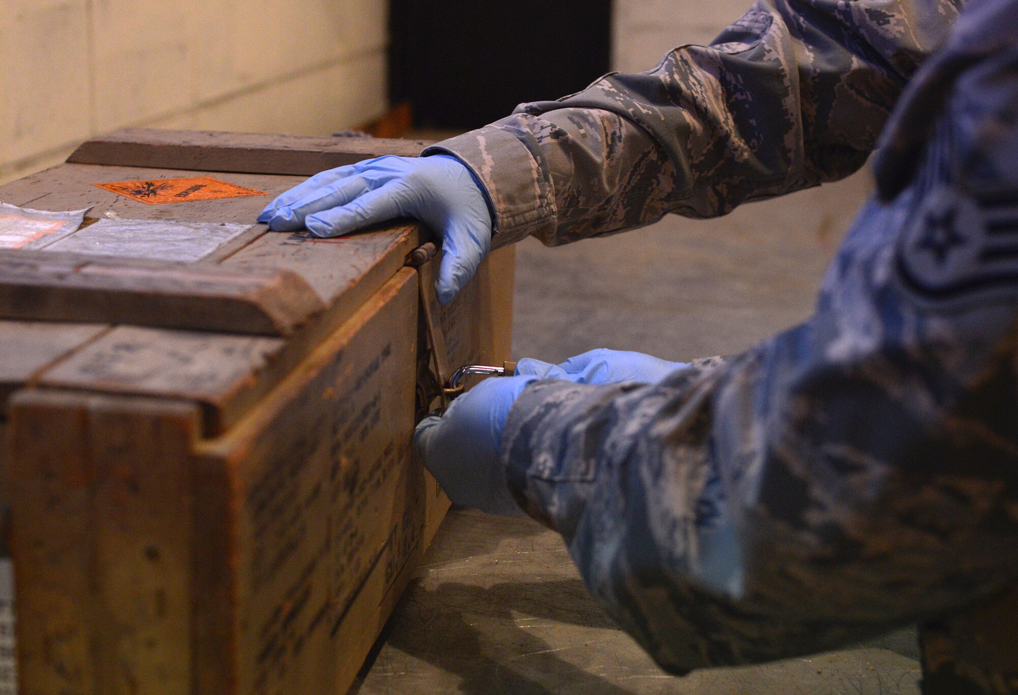 Staff Sgt. Samuel Percy, 374th Maintenance Squadron munitions crew chief, locks away explosive materials at Yokota Air Base, Japan, Nov. 7, 2013. Following basic safety procedures, such as wearing personal protective equipment or properly securing explosives, helps reduce risk to personnel. (U.S. Air Force photo by Airman 1st Class David Danford/Released)