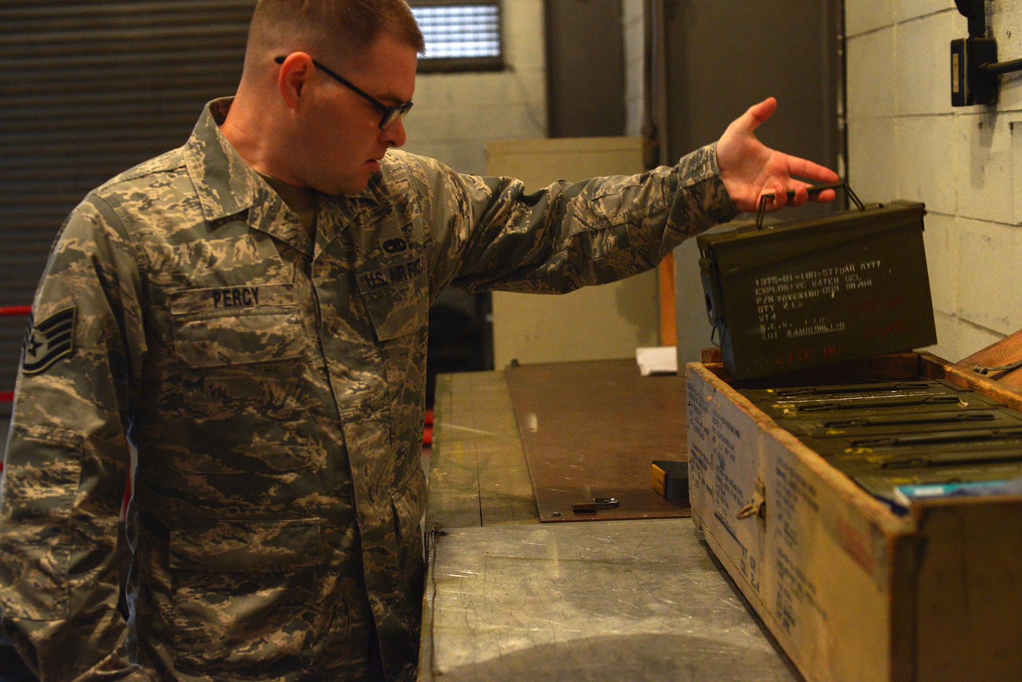 Staff Sgt. Samuel Percy, 374th Maintenance Squadron munitions crew chief, removes a case of explosive water gel from its container at Yokota Air Base, Japan, Nov. 7, 2013. Explosive water gel is used to train military working dogs in bomb detection, and must be regularly inspected for defects. (U.S. Air Force photo by Airman 1st Class David Danford/Released)