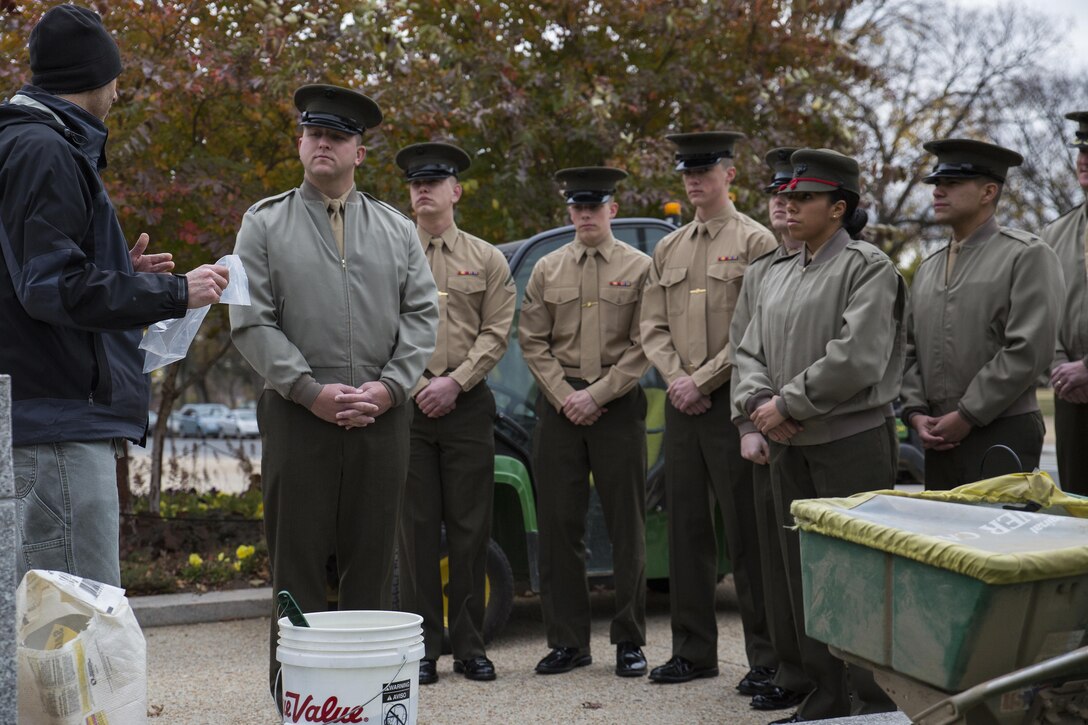 Graham Davis, Smithsonian Gardens horticulturist, shows Marines with Marine Barracks Washington, D.C., how to use a seed spreader in front of the National Museum of American History in Washington, Nov. 12. After the lesson, the Marines participated in the Flanders Field Project, where they spread seeds over the front lawn of the museum to recreate the poppy fields that blossomed on the war-stricken land of Europe in the aftermath of WWI.