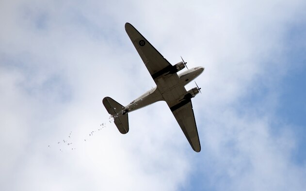 Candy parachutes drop out of a vintage C-47 Skytrain Nov. 9, 2013, near the South Texas Regional Airport in Hondo, Texas. More than 250 members of the community and servicemembers participated in the event. 