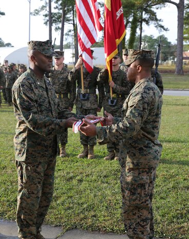 Cpl. Austin Leake, field radio operator with 8th Communications Battalion, presents the Afghanistan Campaign Streamer to Lt. Col. Joseph Delaney, commanding officer of 8th Comm. Bn. aboard Marine Corps Base Camp Lejeune, Nov. 7. After the streamer ceremony, Leake received a Purple Heart for wounds received in action on Nov. 16, 2012 in Afghanistan.