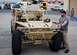 Brandon Johnson, BC Customs designer, explains the specifications of the Guardian Angel Air Deployable Vehicle to Airmen that will be using it for training and real-world situations Nov. 12, 2013, at Nellis Air Force Base, Nev. The vehicle will be able to move through rubble and debris fields during humanitarian assistance and disaster relief efforts to transport survivors and rescue equipment.
