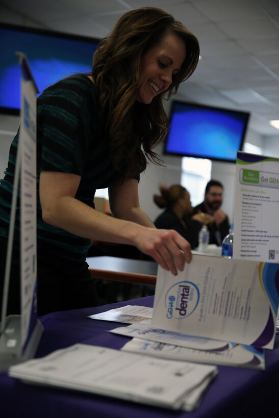 Angela P. Hamline, an account specialist with PPOUSA, a health care program, opens pamplets during the Federal Employee Health Benefit Wellness Fair at the Workforce Learning Center aboard Marine Corps Base Camp Lejeune, Nov. 6. More than 100 employees attended the event.