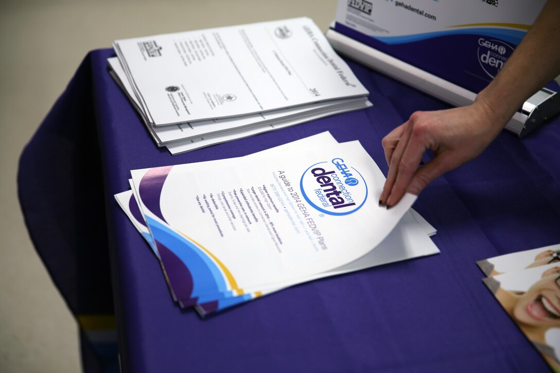 Angela P. Hamline, an account specialist with PPOUSA, a health care program, opens pamplets during the Federal Employee Health Benefit Wellness Fair at the Workforce Learning Center aboard Marine Corps Base Camp Lejeune, Nov. 6. More than 100 employees attended the event.