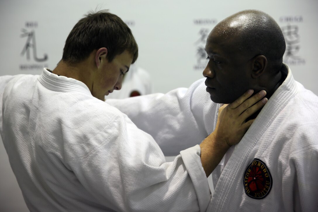 Gregg Pierson, a Jujitsu student, attempts a choke on Donald Hatch, a Jujitsu student, during a class at building 39, next to the Goettge Memorial Field House, aboard Marine Corps Base Camp Lejeune, Nov. 7. Classes are held Tuesdays and Thursdays from 6:30 p.m. to 9 p.m.