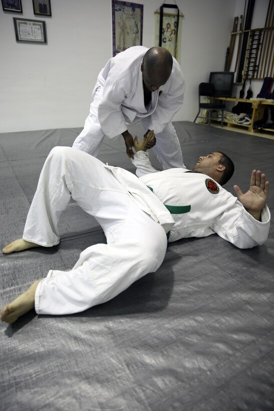 Donald Hatch and Nick Dowden, Jujitsu students, practice self defense techniques during a class at building 39, next to the Goettge Memorial Field House, aboard Marine Corps Base Camp Lejeune, Nov. 7. Classes are held Tuesdays and Thursdays from 6:30 p.m. to 9 p.m.