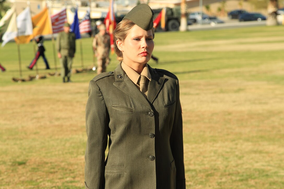 Cpl. Grace Miller, air support systems operations operator, Headquarters Battalion, showcases a Marine Corps uniform from the World War II era during the Marine Corps Birthday Uniform Pageant at Lance Cpl. Torrey Gray Field Nov. 7, 2013.