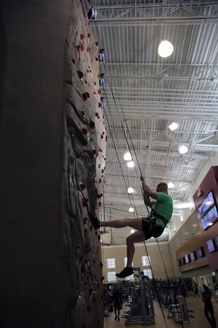 Sgt. Matthew S. Davies, a 26th Marine Expeditionary Unit radio operator, belays down the rock wall at the Wallace Creek Fitness Center aboard Marine Corps Base Camp Lejeune, Nov. 12. The indoor rock wall stands 35 ft. tall and has 15 separate belay lines to ensure climber safety.