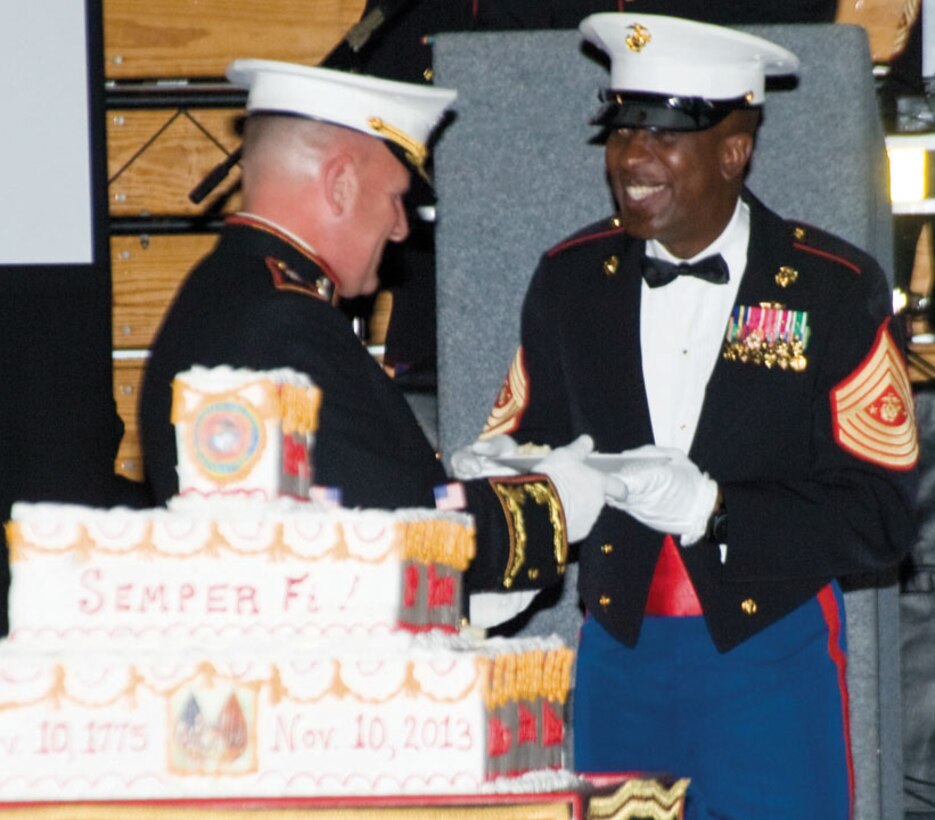 Maj. Gen. John J. Broadmeadow, commanding general, Marine Corps Logistics Command, left, presents a piece of birthday cake to retired Sgt. Maj. Carlton Kent, 16th sergeant major of the Marine Corps, during the 238th Marine Corps Birthday Ball celebration, Friday at Albany State University. 