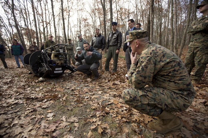Brigadier General Kevin Killea, Marine Corps Warfighting Laboratory Commanding General, listens as Kevin Blankespoor, Vice President of Controls and Autonomy at Boston Dynamics explains how the Legged Squad Support System (LS3) works. The Warfighting Lab is working with the Defense Advanced Research Projects Agency (DARPA) and Boston Dynamics to explore concepts that can potentially lighten the load of Marine units.  LS3, still in the early stages of development, is capable carrying 400 pounds of gear and traversing terrain that wheeled and tracked vehicles cannot.  The Limited Technical Assessment included putting the robot under the control of Marines from the 1st Battalion, 5th Marine Regiment at Camp Pendleton, Calif including animal packers from the Mountain Warfare Training Center in California.
(Official USMC Photo by Kyle J. O. Olson)