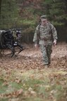 Brigadier General Kevin Killea, Marine Corps Warfighting Laboratory Commanding General, is seen here leading the mule-like robot known as the Legged Squad Support System (LS3) through the woods at Fort Devens, Mass.   The general, wearing  a special pack fitted with thick black bands that the robot is programmed to identify and track, led LS3 through the woods over uneven and sometimes tricky terrain strewn with fallen logs, thick underbrush, and wet leaves sometimes hiding holes and other unseen hazards.  The Warfighting Lab is working with the Defense Advanced Research Projects Agency (DARPA) and Boston Dynamics to explore concepts that can potentially lighten the load of Marine units.  LS3, still in the early stages of development, is capable of carrying 400 pounds of gear and traversing terrain that wheeled and tracked vehicles cannot.  The Limited Technical Assessment included putting the robot under the control of Marines from the 1st Battalion, 5th Marine Regiment at Camp Pendleton, Calif including animal packers from the Mountain Warfare Training Center in California.
(Official USMC Photo by Kyle J. O. Olson)