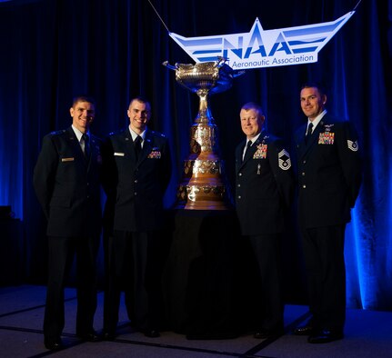 Members of Pedro 83 Flight, from left, Capt. Vincent Powell, Capt. Brion Stroud, Chief Master Sgt. Norman Callahan and Tech. Sgt. John Ballard, accept the Mackay Trophy on behalf of Pedro 83 Flight during a ceremony, in Arlington, Va., Nov. 12, 2013. The trophy is awarded for the "most meritorious flight of the year" by an Air Force person, persons or organization.(U.S. Air Force photo/Staff Sgt. Carlin Leslie)