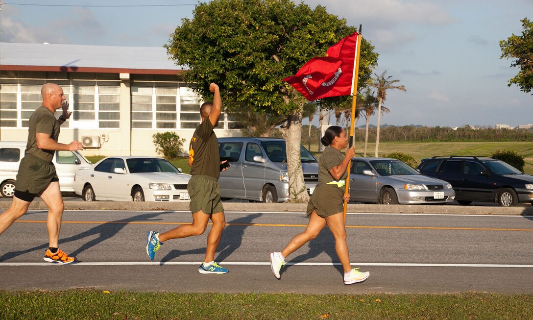Marines participate in the Marine Corps Air Station Futenma's 2013 Marine Corps Birthday Run Nov. 8-10 at the air station. The run was a continuous, 238-mile relay run to celebrate the Marines Corps' 238 years of service. The runners carried a guidon bearing the Marine Corps colors during the event. Each guidon bearer ran one, 10-minute-mile interval before passing the guidon to the next participant. The event ended Nov. 10, the traditional Marine Corps birthday, following morning colors. The Marines are with Headquarters and Headquarters Squadron, MCAS Futenma, Marine Corps Installations Pacific. (U.S. Marine Corps photo by Lance Cpl. Natalie M. Rostran/Released)
