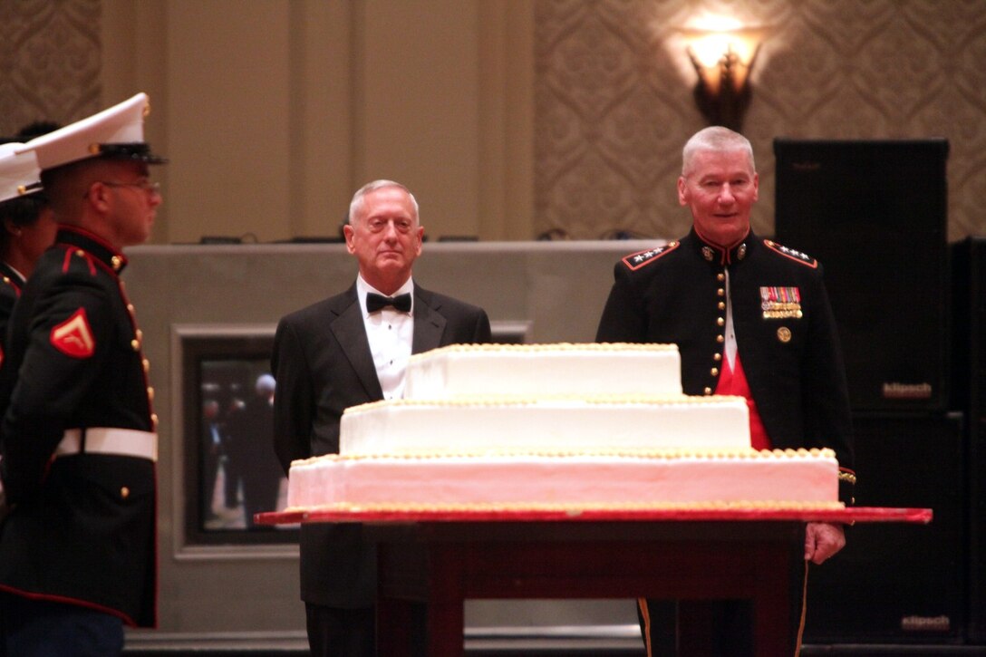Retired Gen.  James N. Mattis and Lt. Gen. John A. Toolan, I Marine Expeditionary Force commanding general, receive the ceremonial cake during the I MEF birthday ball at the Manchester Hyatt in San Diego, Nov. 10, 2013.  Mattis was the guest of honor.