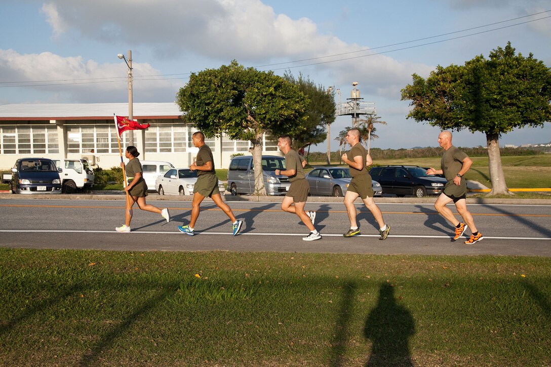 Marines participate in the Marine Corps Air Station Futenma's 2013 Marine Corps Birthday Run Nov. 8-10 at the air station. The run was a continuous, 238-mile relay run to celebrate the Marines Corps' 238 years of service. The runners carried a guidon bearing the Marine Corps colors during the event. Each guidon bearer ran one, 10-minute-mile interval before passing the guidon to the next participant. The event ended Nov. 10, the traditional Marine Corps birthday, following morning colors. The Marines are with Headquarters and Headquarters Squadron, MCAS Futenma, Marine Corps Installations Pacific. (U.S. Marine Corps photo by Lance Cpl. Natalie M. Rostran/Released)