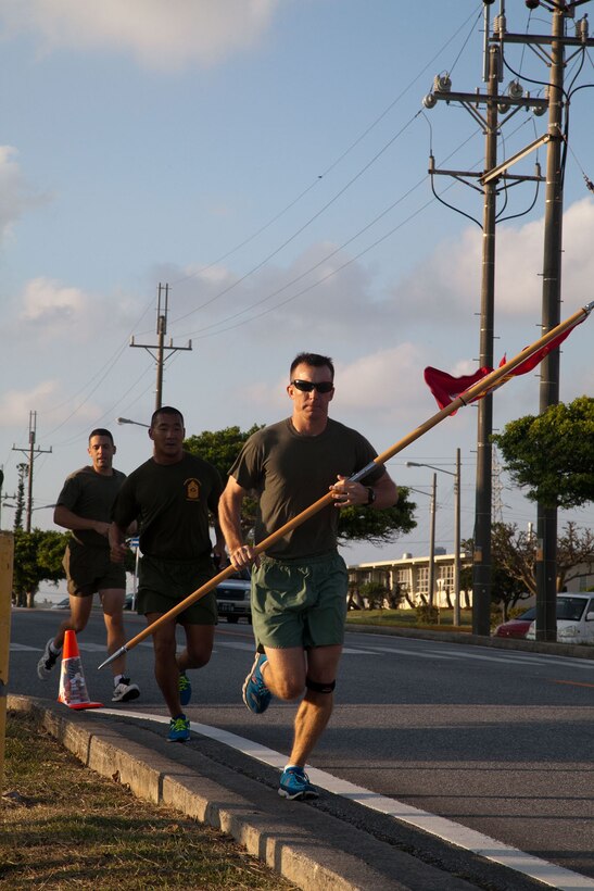 Marines participate in the Marine Corps Air Station Futenma's 2013 Marine Corps Birthday Run Nov. 8-10 at the air station. The run was a continuous, 238-mile relay run to celebrate the Marines Corps' 238 years of service. The runners carried a guidon bearing the Marine Corps colors during the event. Each guidon bearer ran one, 10-minute-mile interval before passing the guidon to the next participant. The event ended Nov. 10, the traditional Marine Corps birthday, following morning colors. The Marines are with Headquarters and Headquarters Squadron, MCAS Futenma, Marine Corps Installations Pacific. (U.S. Marine Corps photo by Lance Cpl. Natalie M. Rostran/Released)