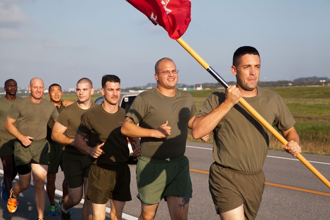 Marines participate in the Marine Corps Air Station Futenma's 2013 Marine Corps Birthday Run Nov. 8-10 at the air station. The run was a continuous, 238-mile relay run to celebrate the Marines Corps' 238 years of service. The runners carried a guidon bearing the Marine Corps colors during the event. Each guidon bearer ran one, 10-minute-mile interval before passing the guidon to the next participant. The event ended Nov. 10, the traditional Marine Corps birthday, following morning colors. The Marines are with Headquarters and Headquarters Squadron, MCAS Futenma, Marine Corps Installations Pacific. (U.S. Marine Corps photo by Lance Cpl. Natalie M. Rostran/Released)