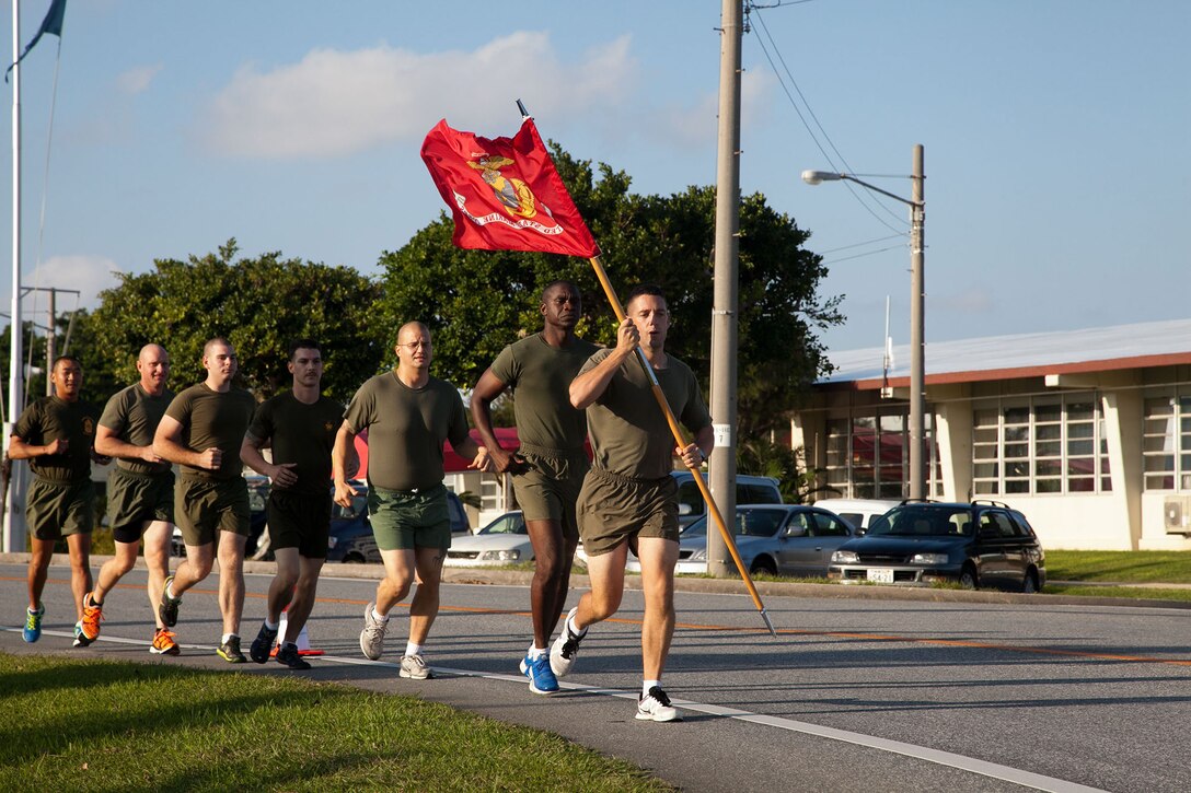 Marines participate in the Marine Corps Air Station Futenma's 2013 Marine Corps Birthday Run Nov. 8-10 at the air station. The run was a continuous, 238-mile relay run to celebrate the Marines Corps' 238 years of service. The runners carried a guidon bearing the Marine Corps colors during the event. Each guidon bearer ran one, 10-minute-mile interval before passing the guidon to the next participant. The event ended Nov. 10, the traditional Marine Corps birthday, following morning colors. The Marines are with Headquarters and Headquarters Squadron, MCAS Futenma, Marine Corps Installations Pacific. (U.S. Marine Corps photo by Lance Cpl. Natalie M. Rostran/Released)