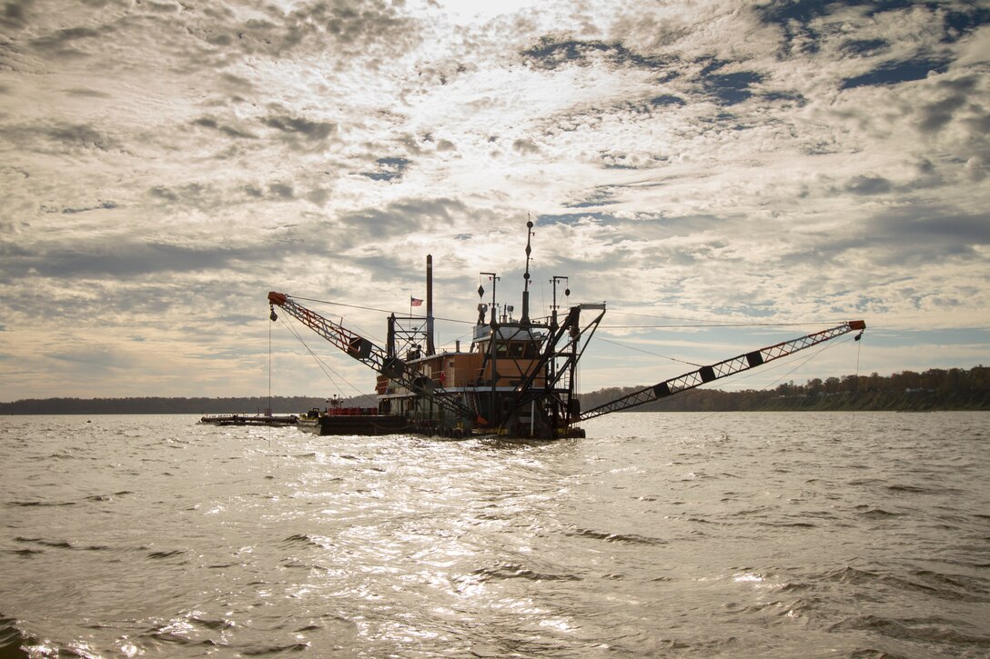 The crew of the Cottrell Contracting Corporation Dredge Marion works to remove shoals from the James River federal navigation channel just off shore from James City County, Va., Nov. 6 2013. The river plays a role in the economies of Richmond and Hopewell, providing a navigation channel of 25 feet deep for ships to move goods to and from the inland ports. (U.S. Army photo/Patrick Bloodgood)