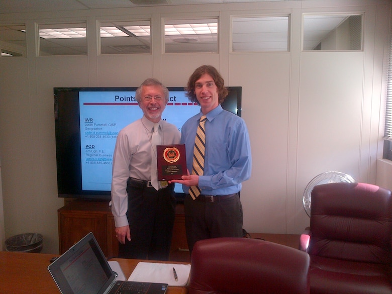 IWR Geography Justin Pummell (right) receives IWR Special Act of the Year award from IWR Director Robert Pietrowsky (left).
