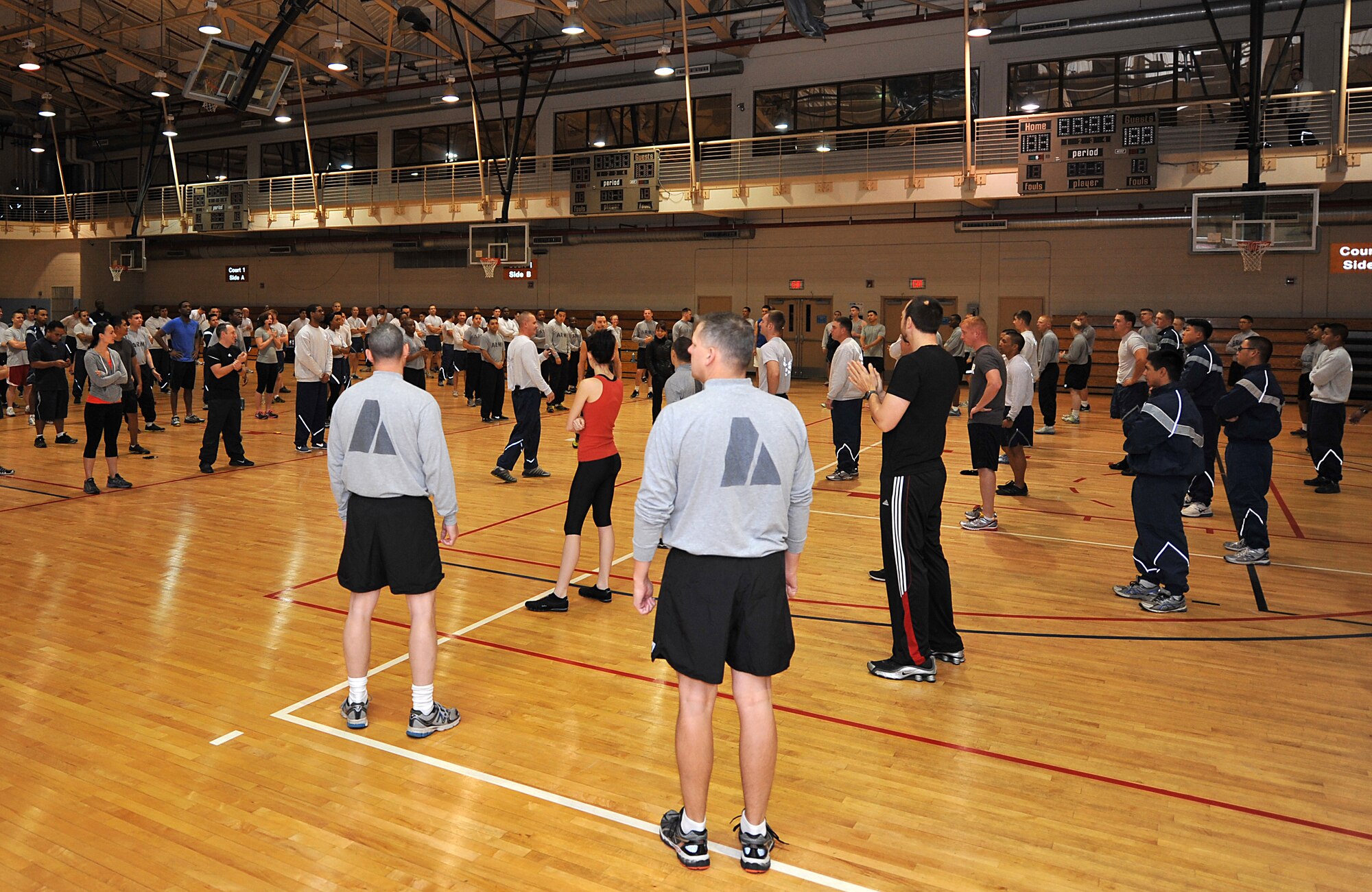 Members of Team Osan prepare to warm up before a P90X workout in the fitness center at Osan Air Base, Republic of Korea, Nov. 15, 2013. Tony Horton, P90X creator, visited Osan as part of a tour of 42 different military installations. (U.S. Air Force photo/Airman 1st Class Ashley J. Thum)