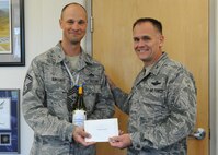 Senior Master Sgt. Todd Kirsch, 647th Civil Engineer Squadron operations superintendent, accepts a congratulatory letter and promotion memento this week shortly after being notified of his promotion to chief master sergeant by Col. Johnny Roscoe, 15th Wing commander, at 15th Wing headquarters building, at Joint Base Pearl Harbor-Hickam, Hawaii.  All chief master sergeants are expected to serve as mentors for company-grade and field-grade commissioned officers, as well as noncommissioned officers and junior enlisted members, and to serve as advisors to unit commanders and senior officers. (U.S. Air Force photo/Tech. Sgt. Jerome S. Tayborn)