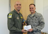 Senior Master Sgt. Bill Fitch, 96th Air Refueling Squadron superintendent, accepts a congratulatory letter and promotion memento this week shortly after being notified of his promotion to chief master sergeant by Col. Johnny Roscoe, 15th Wing commander at 15th Wing headquarters building, Joint Base Pearl Harbor-Hickam, Hawaii. Chief master sergeants manage the efforts of all enlisted personnel within their unit or major subsection thereof, and run major staff functions at higher headquarters levels. (U.S. Air Force photo/Tech. Sgt. Jerome S. Tayborn)