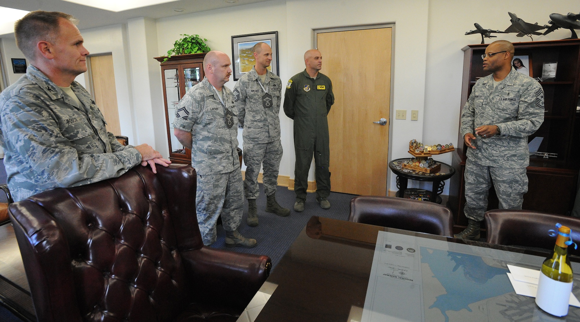 Chief Master Sgt. Leslie Bramlett, 15th Wing command chief, right, addresses newly appointed chief master sergeant selects, Senior Master Sgt. Todd Larsen, 747th Communications Squadron flight chief, Senior Master Sgt. Todd Kirsch, 647th Civil Engineer Squadron operations superintendent, and Senior Master Sgt. Bill Fitch, 96th Air Refueling Squadron superintendent, this week, as Col. Johnny Roscoe, 15th Wing commander, left, looks on, in the 15th Wing headquarters building, at  Joint Base Pearl Harbor-Hickam, Hawaii.  (U.S. Air Force photo/Tech. Sgt. Jerome S. Tayborn)