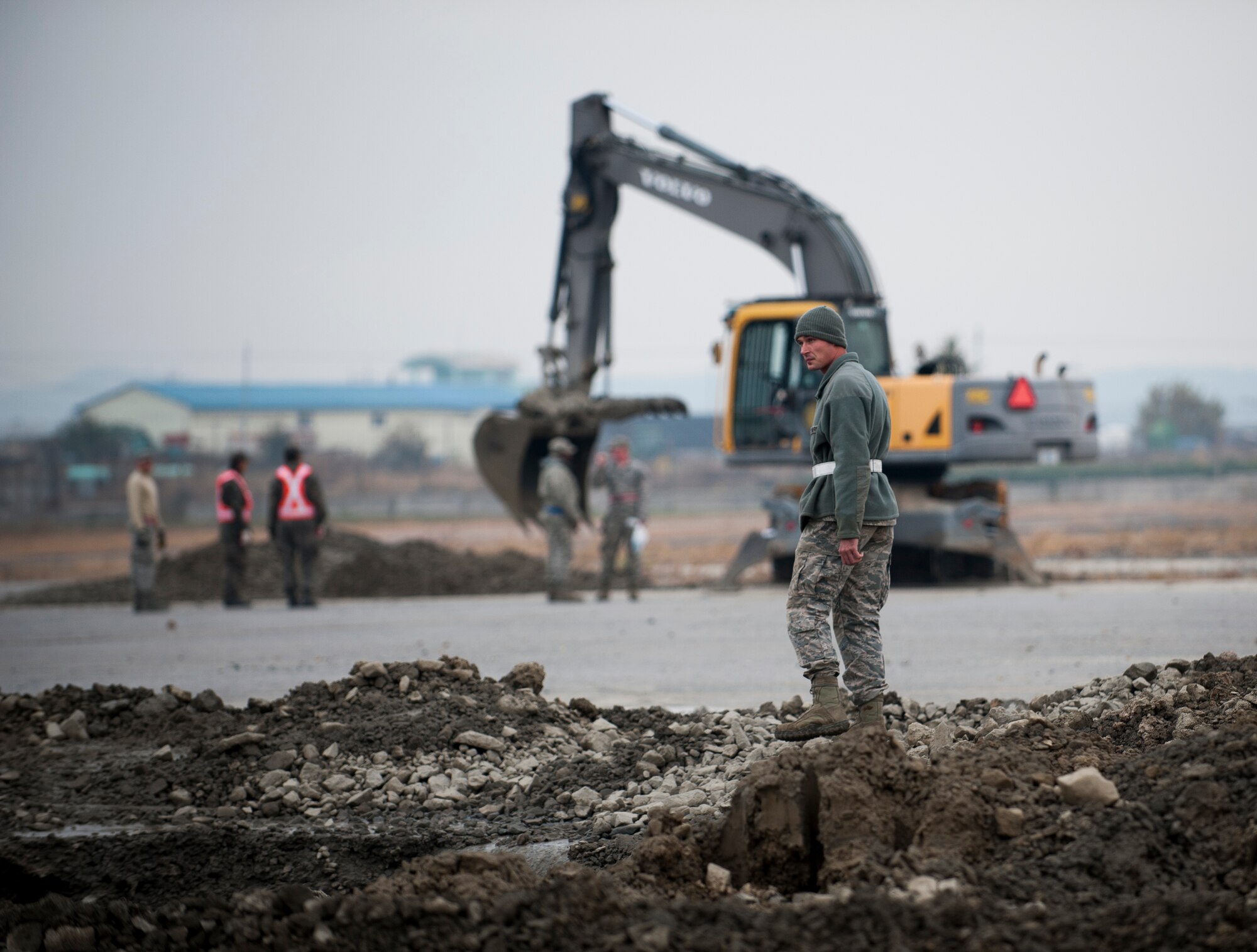 Staff Sgt. Richard Simmons, 8th Civil Engineer Squadron, observes a combined Airfield Damage Repair Exercise at Kunsan Air Base, Republic of Korea, Nov. 14, 2013. The exercise with ROK air force's 1st Civil Engineer Squadron allowed members of both air forces to work together, learn different methods and become more proficient with airfield repairs. (U.S. Air Force photo by Senior Airman Clayton Lenhardt/Released)