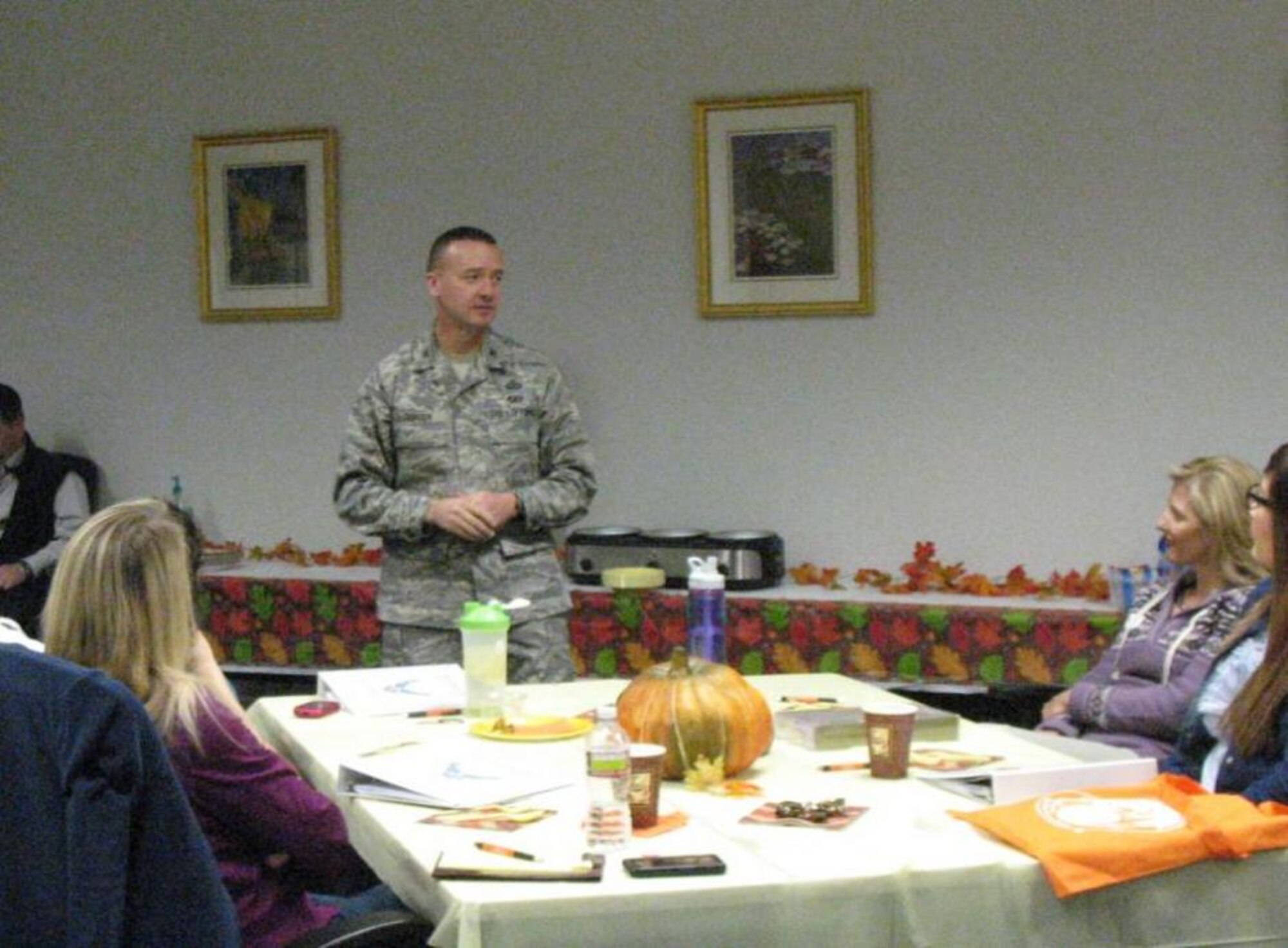New military spouses to Hill listen to a presentation by Col. Frederick Thaden, 75th Air Base Wing vice commander, as he welcomes them to the base. 