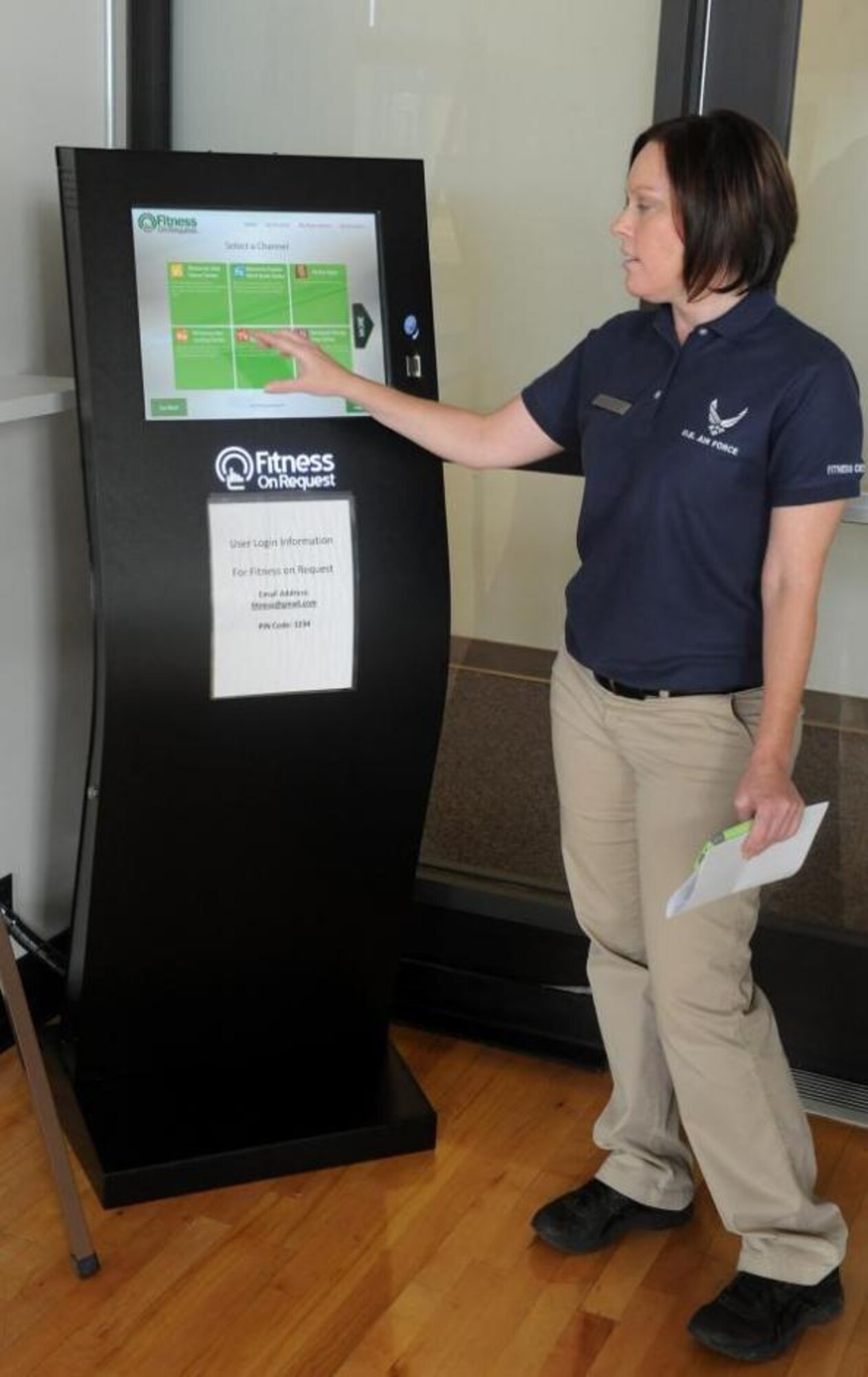Carey Karger, Fitness Center director, demonstrates the use of the new fitness kiosk available for use either through scheduled classes or in smaller groups.