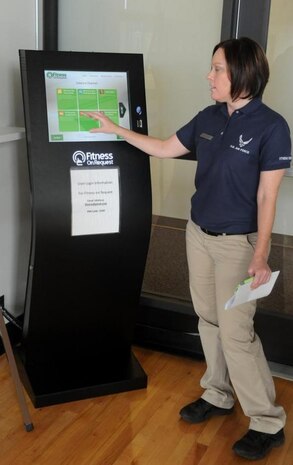 Carey Karger, Fitness Center director, demonstrates the use of the new fitness kiosk available for use either through scheduled classes or in smaller groups.