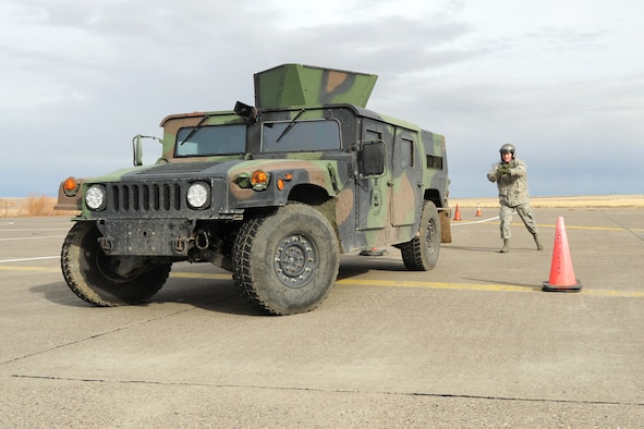 1st Lt. Lee Feldhausen, 341st Operations Support Squadron ICBM instructor combat crew commander, spots a driver as he parallel parks a Humvee during the 10th Missile Squadron Humvee Olympics on the Malmstrom Air Force Base flightline Nov. 8. More than 30 Airmen from the 10th MS participated in the event. (U.S. Air Force photo/Senior Airman Katrina Heikkinen)