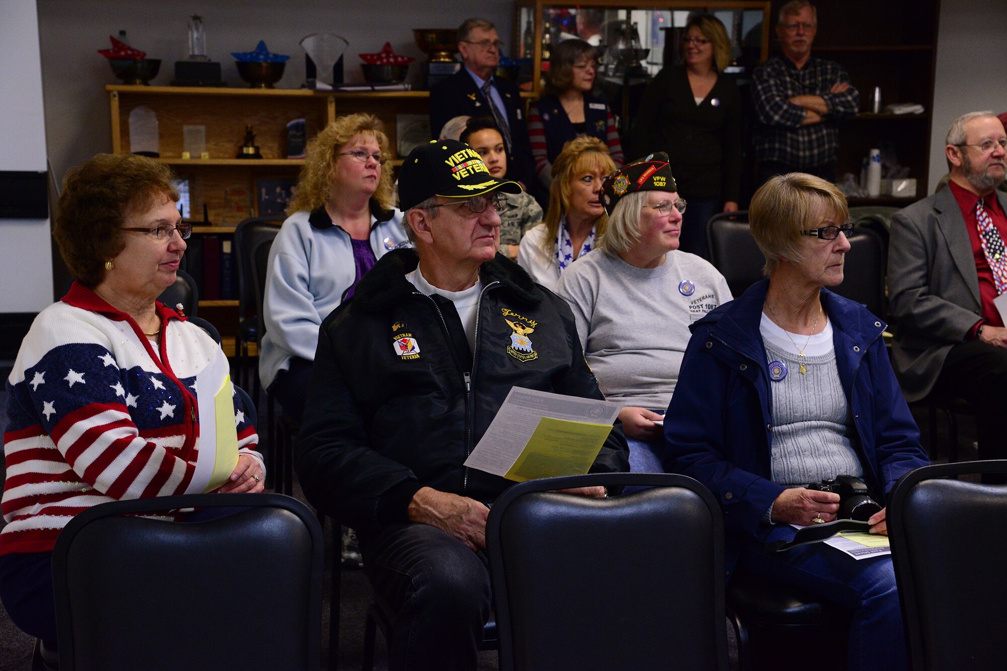 Vietnam War veterans listen to a commemoration speech during a flag presentation ceremony at the Malmstrom Air Force Base Commissary on Nov 8. During the ceremony, a brand new flag marking the 50th anniversary of the Vietnam War and commemoration plaque honoring the contribution service members made during the war was unveiled for the first time to veterans at Malmstrom. (U.S. Air Force photo/Airman 1st Class Collin Schmidt)