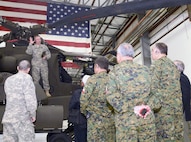 The Chilean army delegation receives a briefing on the AH-64 Apache helicopter while in Austin Nov. 7. The Chilean delegation visited Texas to participate in the army-to-army staff talks between U.S. Army South and the Chilean army Nov. 5-7. (Army Photo by Eric Lucero, U.S. Army South Public Affairs)