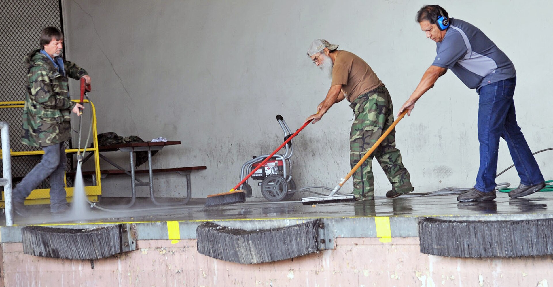 Civilian workers from the 502nd Civil Engineer Squadron pressure wash the loading dock at building 4189 during Pride Day. (Photo by Olivia Mendoza, JBSA-Fort Sam Houston Public Affairs)