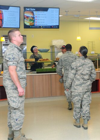 Team Beale members order food at the Contrails Dining Facility during the grand reopening at Beale Air Force Base, Calif., Nov. 14, 2013. Contrails now has eight different food stations: Mainline entrée, Mongolian grill, UFood, Deli and Pizza, Salad bar, Grab N’ Go and Soup station. (U.S. Air Force photo by Senior Airman Allen Pollard/Released)