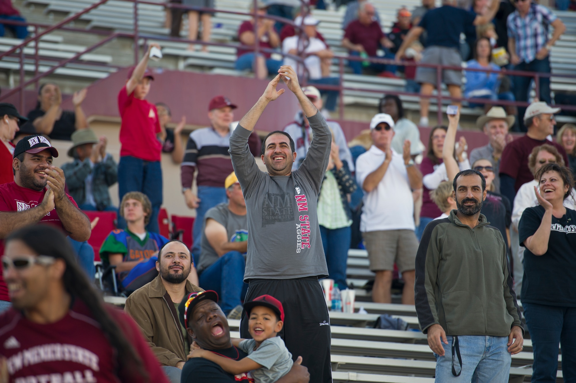 New Mexico State University football fans celebrate an Aggie touchdown at Aggie Memorial Stadium in Las Cruces, N.M., Nov. 9. NMSU hosted Boston College for their annual military appreciation game, which honored current and past military veterans. (U.S. Air Force photo by Airman 1st Class Aaron Montoya/Released)