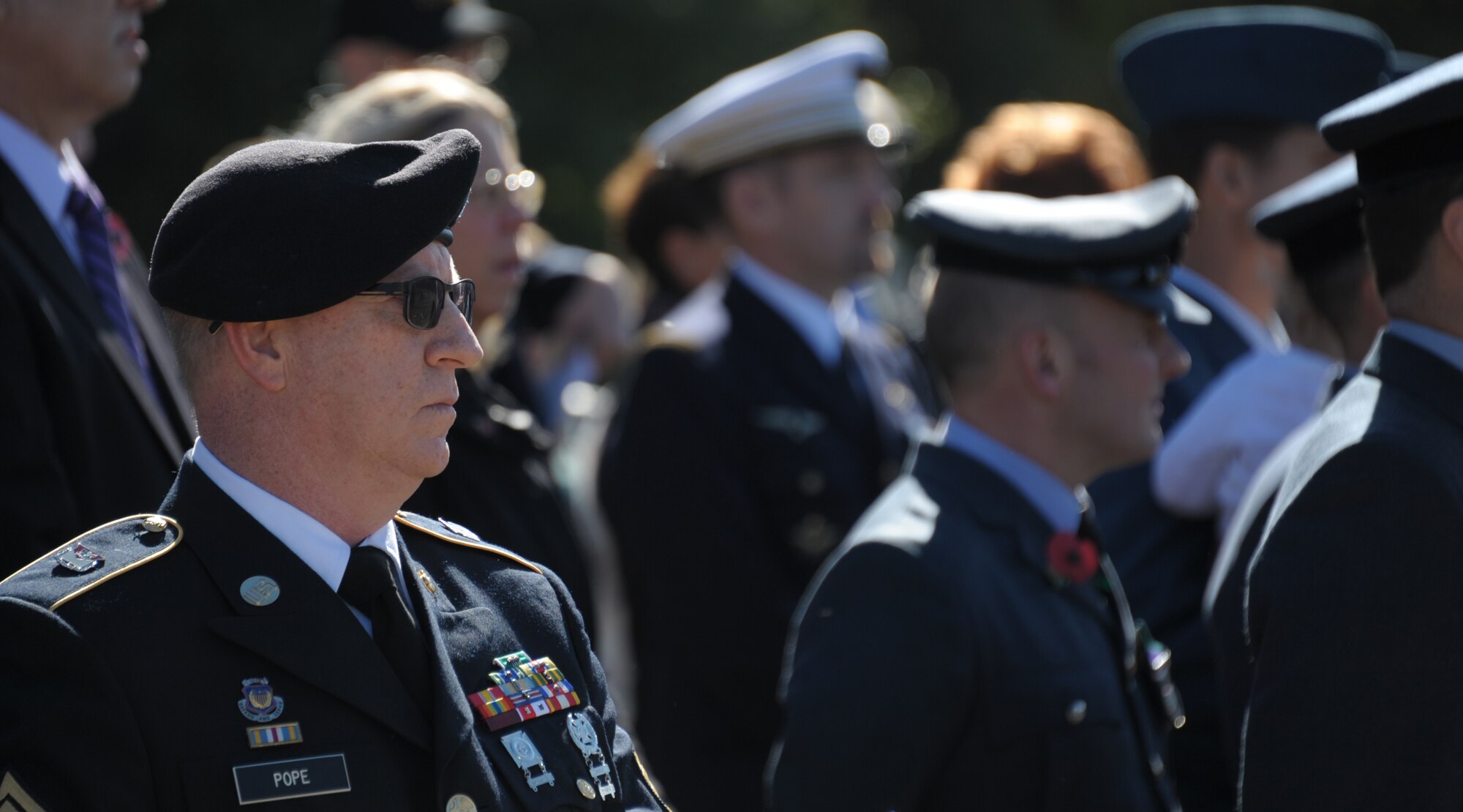 First Sgt. Roy Pope, 151st Army Band bugler, watches a Remembrance Day Ceremony hosted by officers of the Royal Air Force and French Air Force, attending professional military education courses at Maxwell Air Force Base. The international officers hold a special annual memorial service at the graves of 78 RAF and 20 FAF flight cadets located in Oakwood Cemetery, Montgomery, Ala. The cadets died from training accidents in the southeast United States during World War II. (U.S. Air Force photo by Staff Sgt. Gregory Brook)