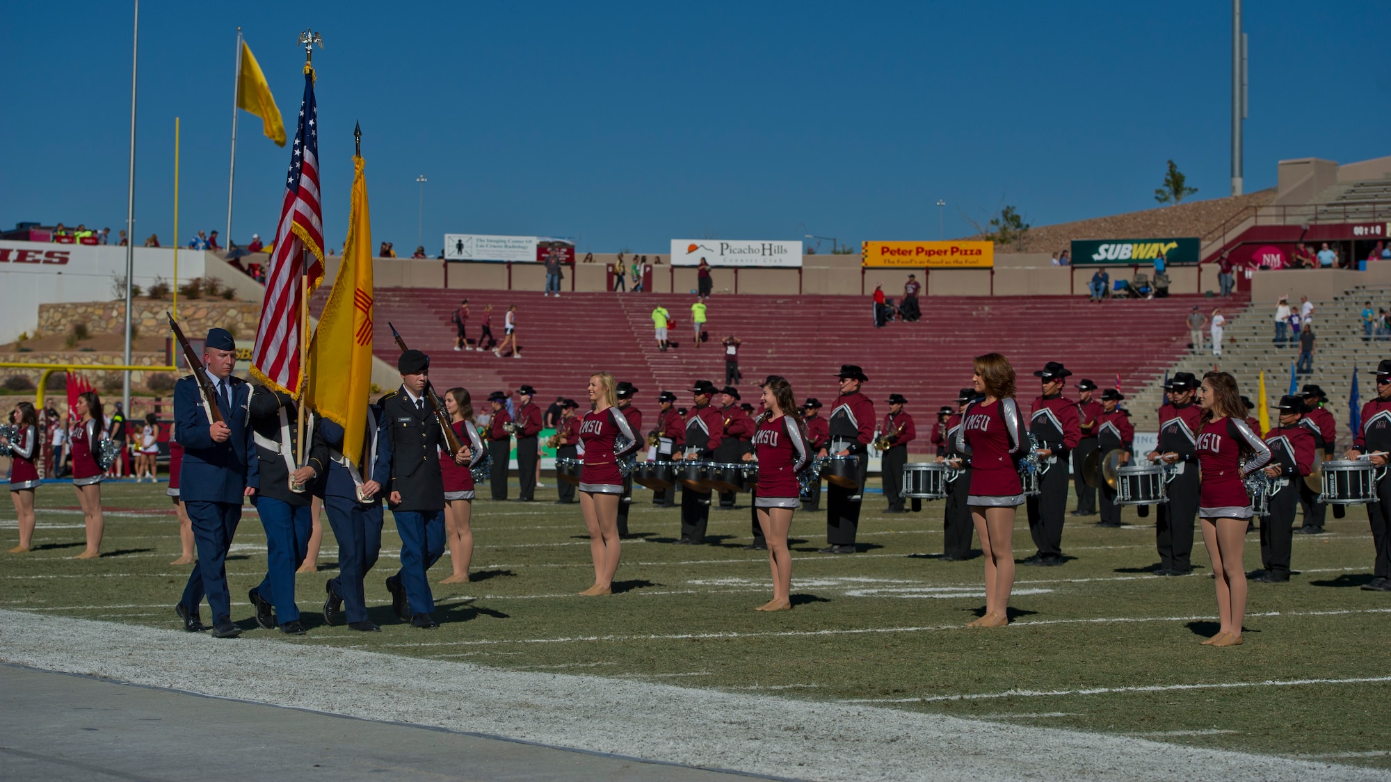 A ROTC color guard, consisting of Army and Air Force members displays the United States and New Mexican flags during the opening ceremony at Aggie Memorial Stadium in Las Cruces, N.M., Nov. 9. NMSU hosted Boston College for their annual military appreciation game, which honored current and past military veterans. (U.S. Air Force photo by Airman 1st Class Aaron Montoya/Released)