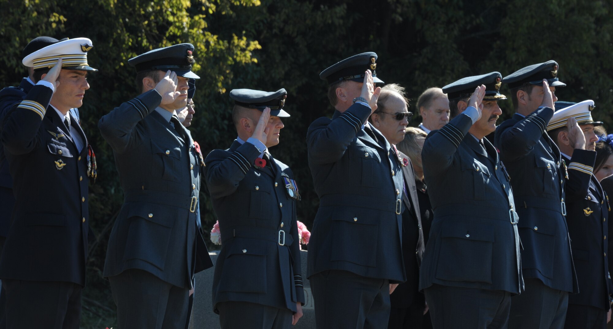 Representatives from the Royal Air Force and the French Air Force salute the graves of French and British soldiers during a Remembrance Day Ceremony hosted by officers of the RAF and FAF, attending professional military education courses at Maxwell Air Force Base. The international officers hold a special annual memorial service at the graves of 78 RAF and 20 FAF.  The cadets died from training accidents in the southeast United States during World War II. (U.S. Air Force photo by Staff Sgt. Gregory Brook)