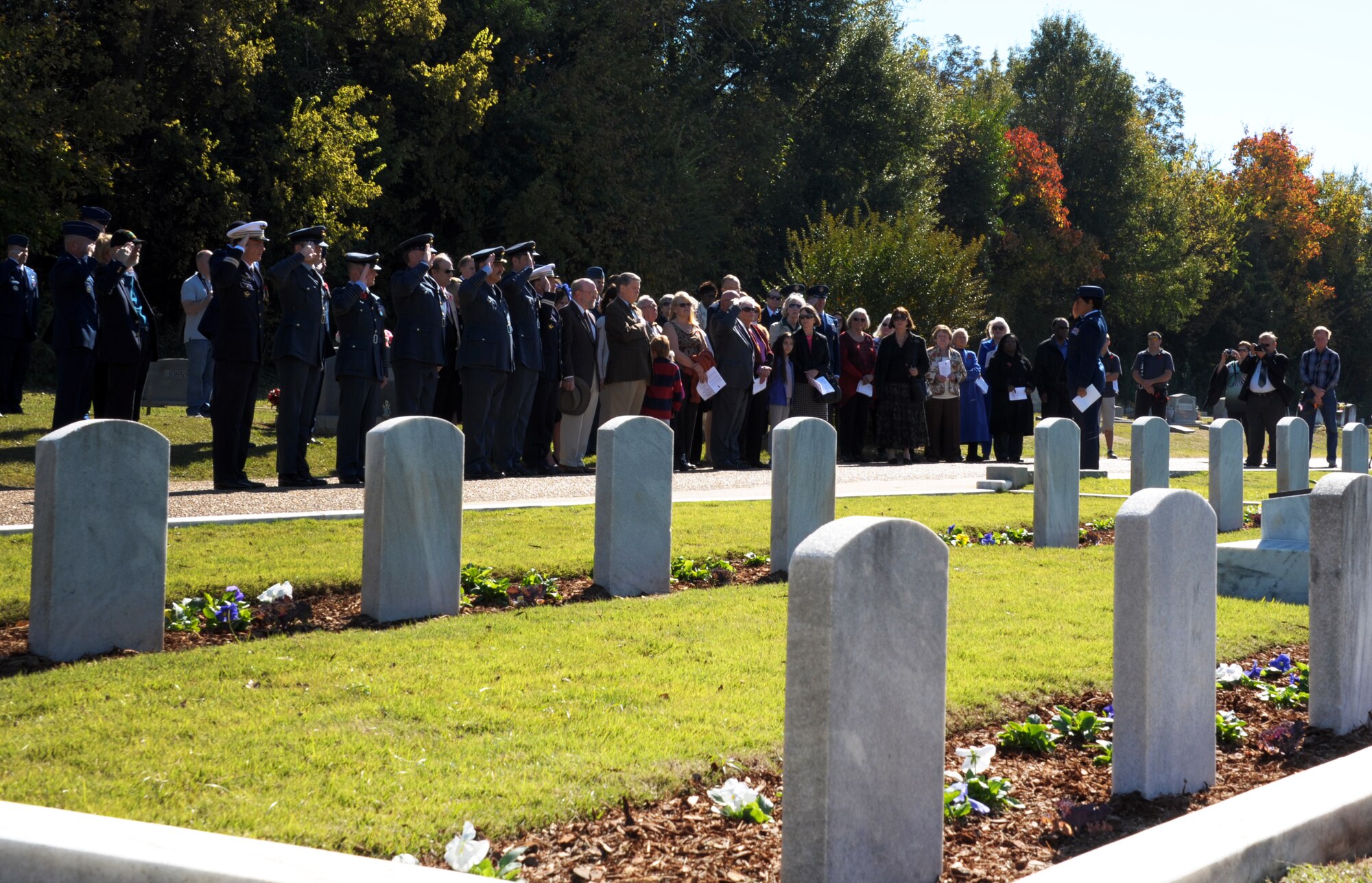 Members of the Royal Air Force, the French Air Force, the U.S. Air Force, and members of the Maxwell community salute the graves of British and French Flight cadets located in Oakwood Cemetery, Montgomery, Ala., in a Remembrance Day Ceremony hosted by officers of the RAF and FAF attending professional military education courses at Maxwell Air Force Base. The international officers hold a special annual memorial service at the graves of 78 RAF and 20 FAF flight cadets, who died from training accidents in the southeast United States during World War II. (U.S. Air Force photo by Staff Sgt. Gregory Brook)