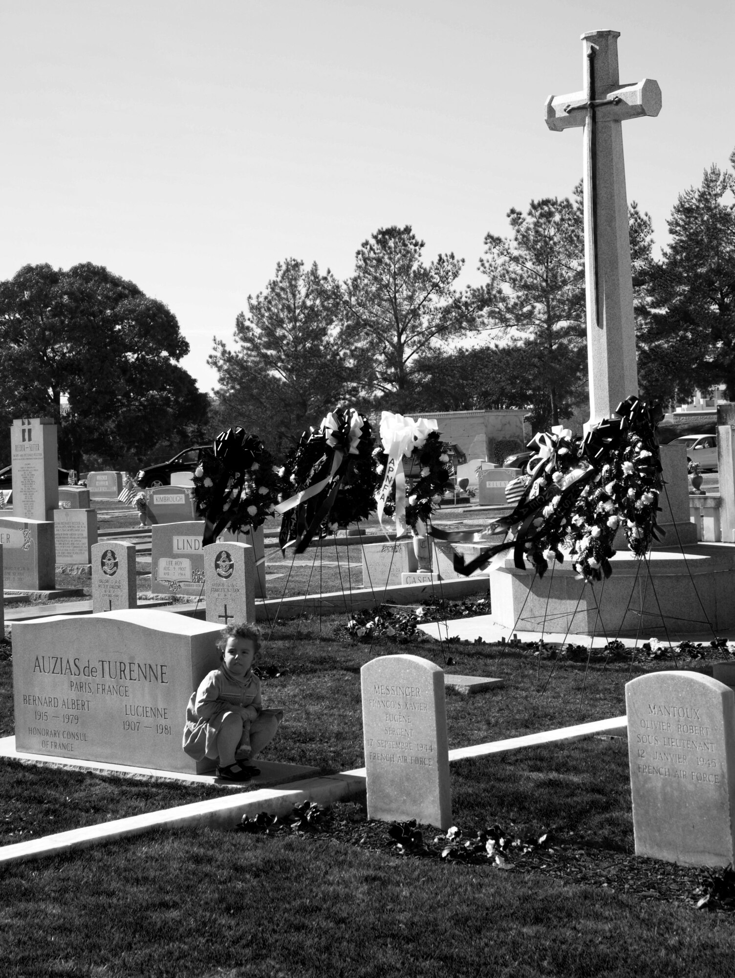 Jeanne Gaudilliere, daughter of Lt. Col. Pierre Gaudilliere, a French Air Force student at Air War College, part of the Carl A. Spaatz Center for Officer Education locate at Maxwell Air Force Base, looks at the graves of fallen FAF flight cadets during the annual Remembrance Day Ceremony held at Oakwood Cemetery in Montgomery, Ala. The ceremony is held to mark the sacrifice of 78 RAF and 20 FAF flight cadets, who died from training accidents in the southeast United States during World War II. (U.S. Air Force photo by Staff Sgt. Gregory Brook)