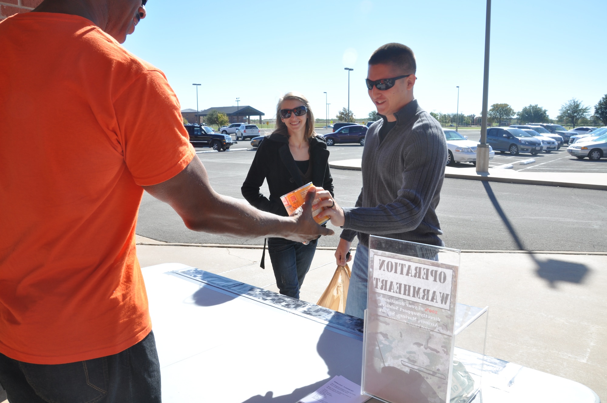 GOODFELLOW AIR FORCER BASE, Texas- A Team Goodfellow member donates food to Operation Warmheart in front of the Base Commissary Nov. 9. Food collected for Operation Warmheart goes to  gift baskets built for families on Goodfellow for the holidays. (U.S. Air Force photo/ Airman 1st Class Erica Rodriguez)